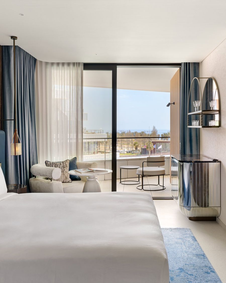 Guest room at SLS Barcelona with a terrace over the marina